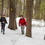 Hikers trek along a trail at the Wentworth-Coolidge Mansion State Historic Site in Portsmouth, N.H.